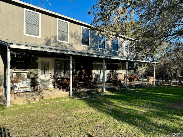 back of house featuring a yard and a patio area