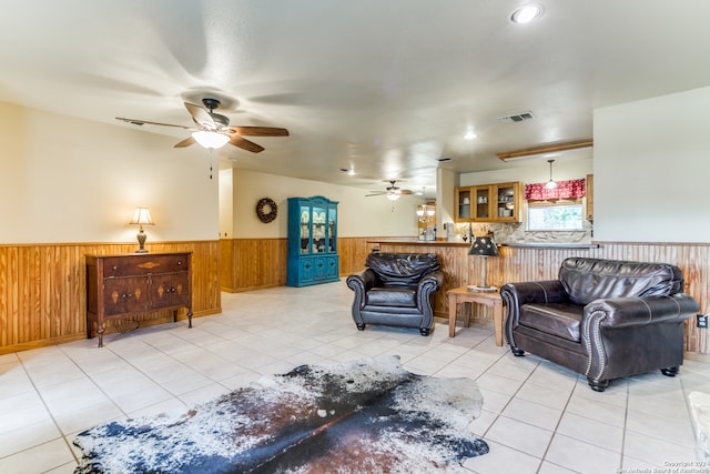 tiled living room featuring ceiling fan