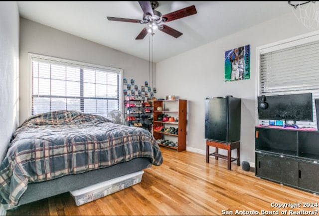 bedroom with hardwood / wood-style floors and ceiling fan