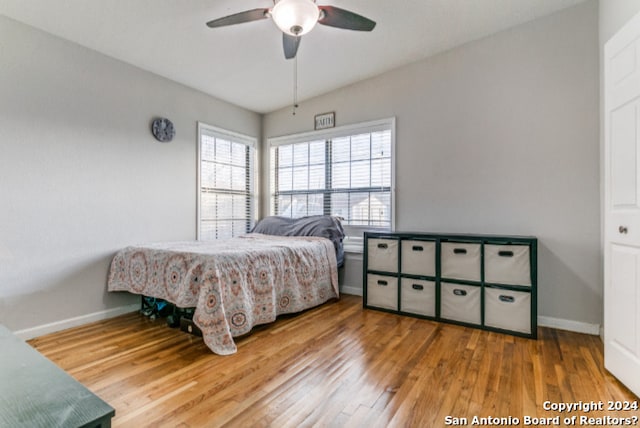 bedroom with hardwood / wood-style floors and ceiling fan