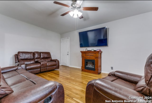 living room featuring ceiling fan and hardwood / wood-style floors