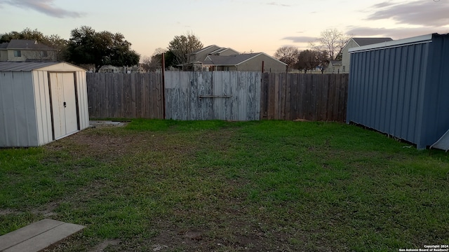 yard at dusk with a storage unit