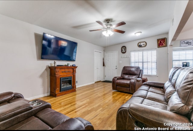 living room with hardwood / wood-style flooring and ceiling fan