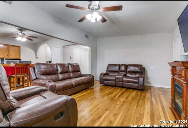 living room with ceiling fan and light wood-type flooring