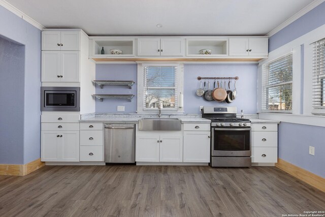 kitchen featuring white cabinets, sink, wood-type flooring, and stainless steel appliances