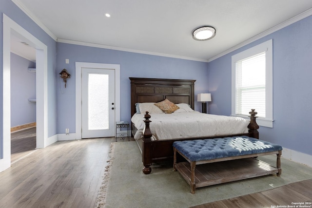 bedroom featuring light hardwood / wood-style flooring and ornamental molding