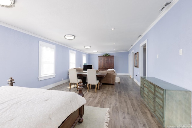 bedroom featuring crown molding and light hardwood / wood-style flooring