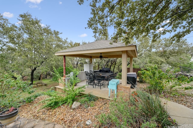 view of yard featuring an outdoor bar, a patio, and ceiling fan