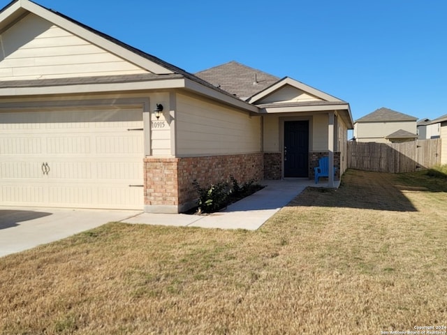 single story home with a front lawn and a garage