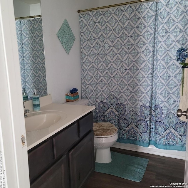 full bathroom featuring hardwood / wood-style floors, toilet, tile walls, and vanity