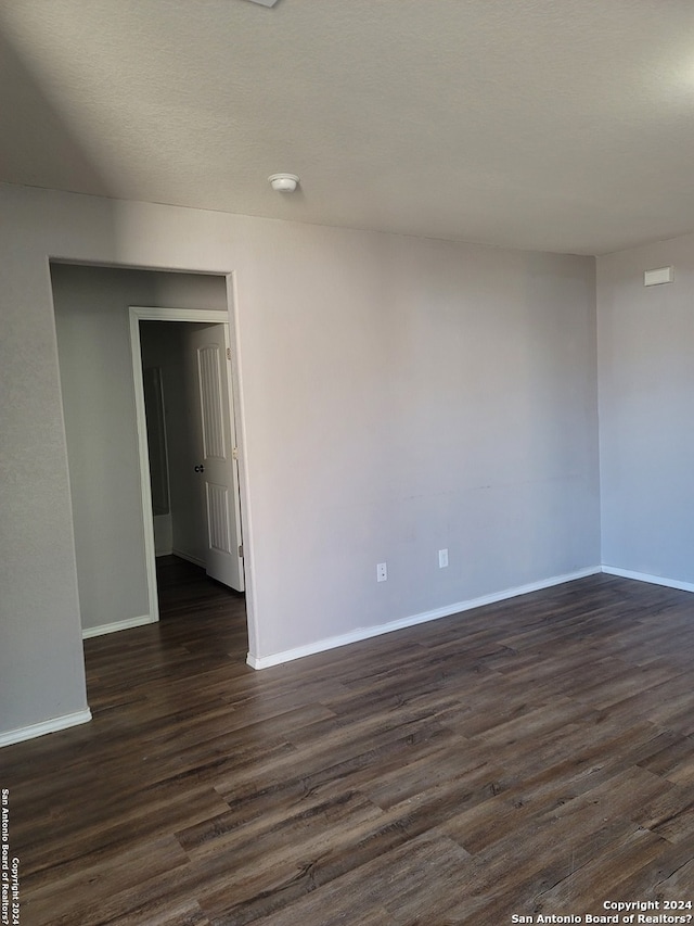 spare room with dark hardwood / wood-style flooring