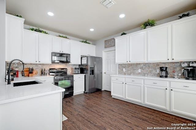 kitchen featuring black appliances, decorative backsplash, white cabinets, sink, and dark hardwood / wood-style floors