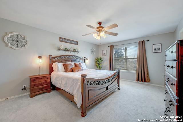 carpeted bedroom featuring ceiling fan