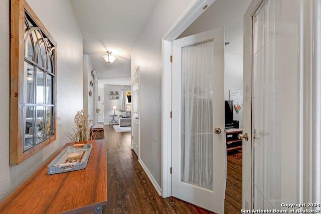 hall with dark hardwood / wood-style flooring