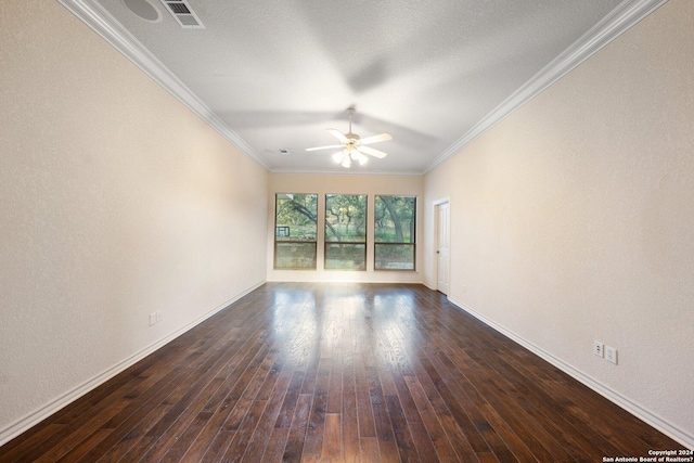 unfurnished room with visible vents, ornamental molding, dark wood finished floors, baseboards, and ceiling fan
