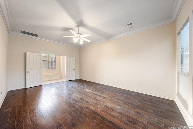 empty room with ceiling fan, visible vents, dark wood-style floors, and crown molding