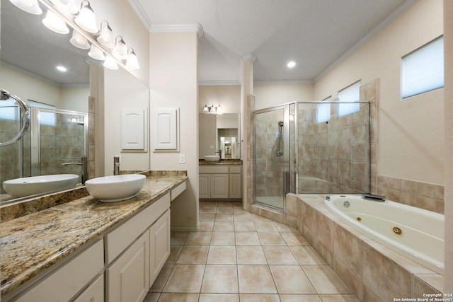 bathroom featuring crown molding, two vanities, a stall shower, and a sink