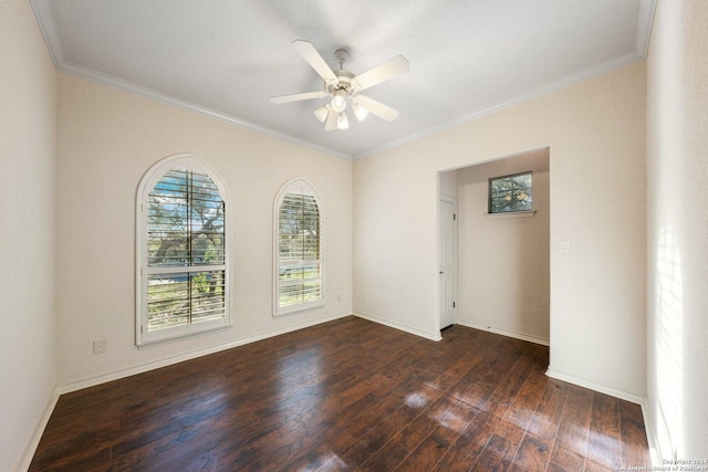 empty room featuring a ceiling fan, dark wood-style floors, baseboards, and ornamental molding