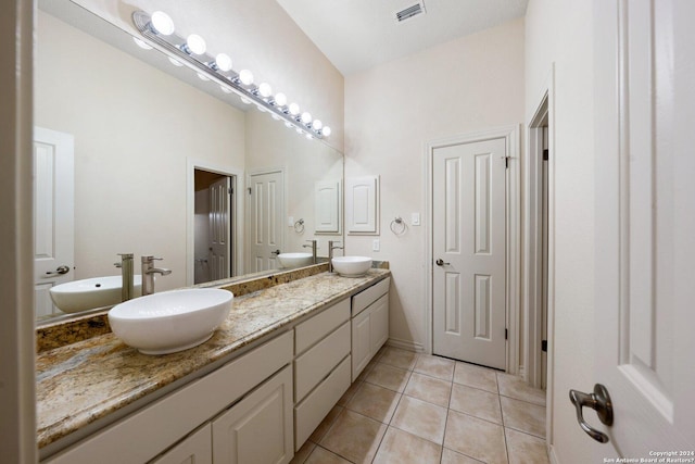 bathroom with a sink, visible vents, and tile patterned floors