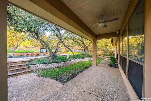 view of patio with a ceiling fan and fence