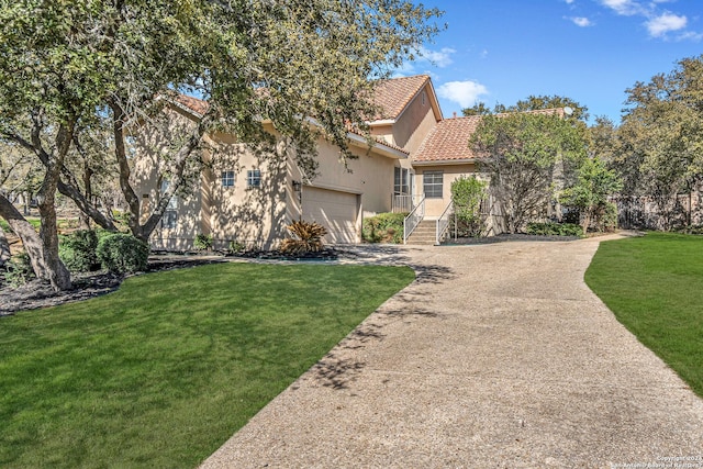 view of yard with a garage and driveway
