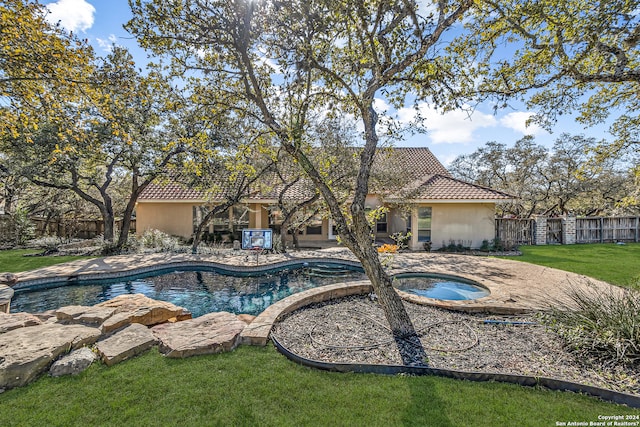 view of pool featuring a lawn, a patio, fence, a fenced in pool, and an in ground hot tub
