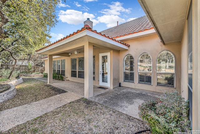 view of patio with ceiling fan and fence