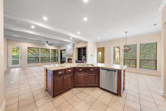 kitchen featuring visible vents, open floor plan, a fireplace, stainless steel dishwasher, and a sink