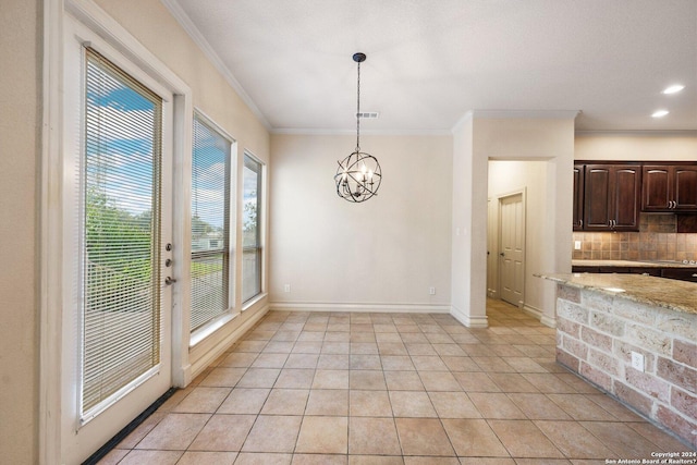 unfurnished dining area featuring a chandelier, light tile patterned flooring, baseboards, and ornamental molding