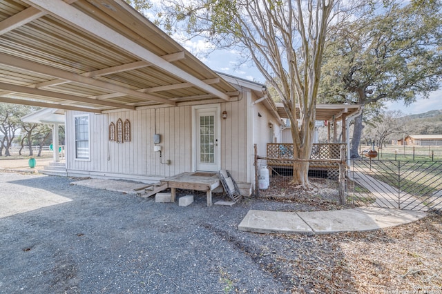 entrance to property featuring a carport