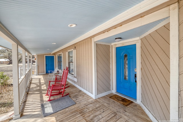 view of exterior entry featuring a porch