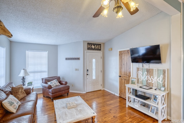 living room featuring ceiling fan, vaulted ceiling, hardwood / wood-style floors, and a healthy amount of sunlight