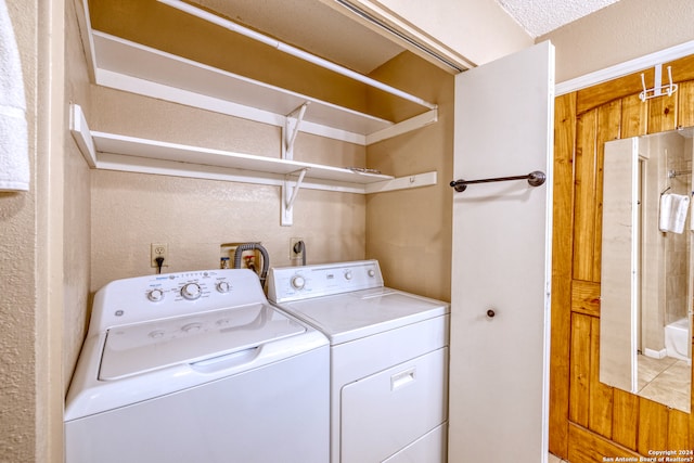 washroom with washing machine and clothes dryer