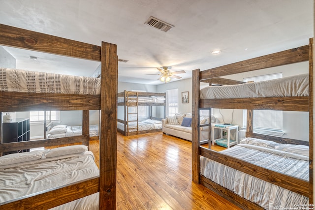 bedroom with ceiling fan and light hardwood / wood-style floors