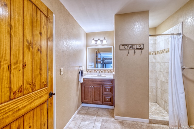 bathroom with tile patterned flooring, vanity, and curtained shower