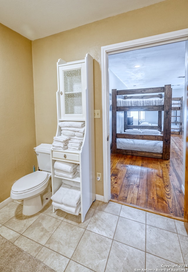 bathroom with hardwood / wood-style floors and toilet