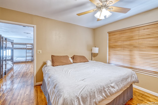 bedroom with ceiling fan and wood-type flooring