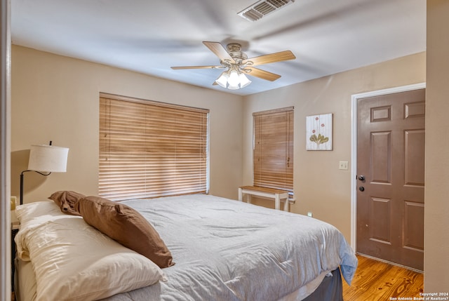 bedroom with ceiling fan and wood-type flooring