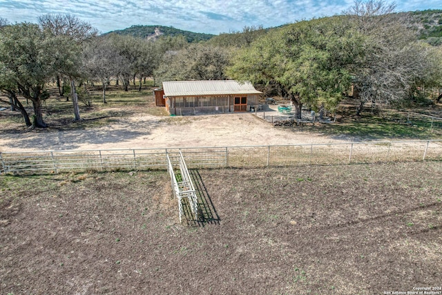 exterior space featuring a rural view and an outbuilding