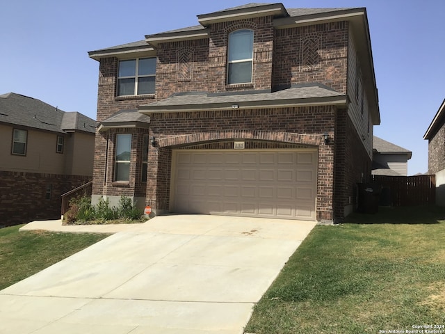 front of property featuring a front lawn and a garage