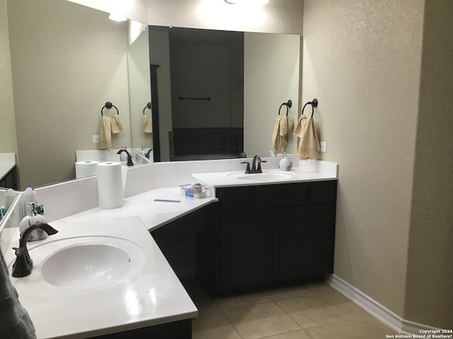 bathroom with dual vanity and tile flooring