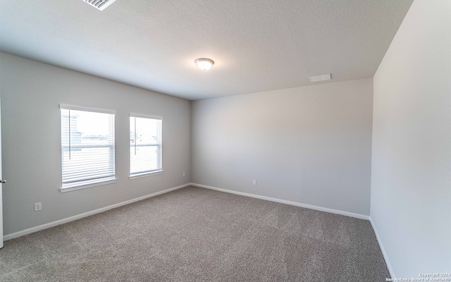 unfurnished room featuring a textured ceiling and carpet flooring