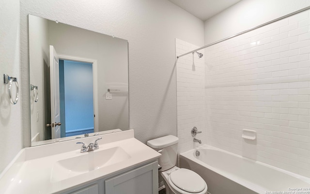 full bathroom with tiled shower / bath combo, vanity, and toilet