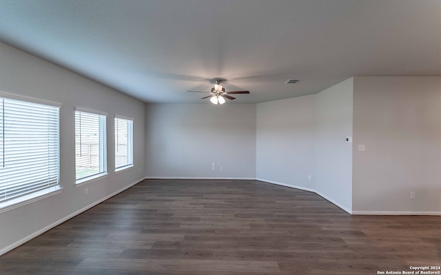 empty room with ceiling fan and dark hardwood / wood-style floors