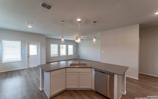 kitchen featuring dark hardwood / wood-style floors, sink, a kitchen island with sink, and stainless steel dishwasher