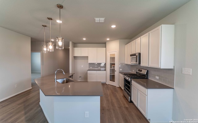 kitchen with stainless steel appliances, dark hardwood / wood-style flooring, tasteful backsplash, and sink