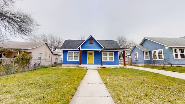 bungalow-style house with a front yard