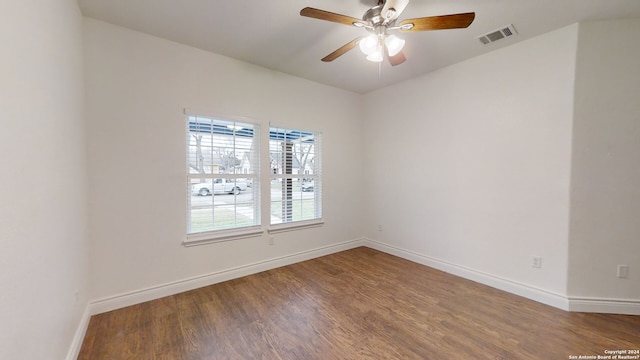 spare room featuring ceiling fan and dark hardwood / wood-style floors