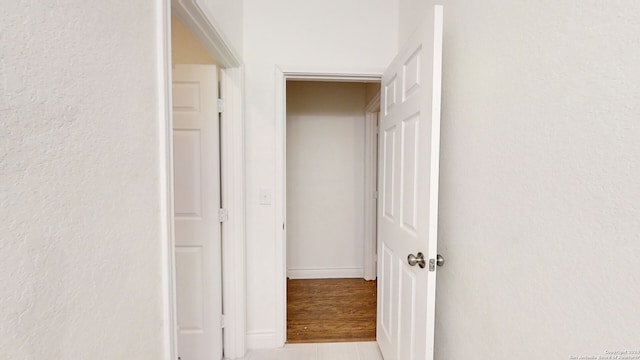 corridor with light hardwood / wood-style floors