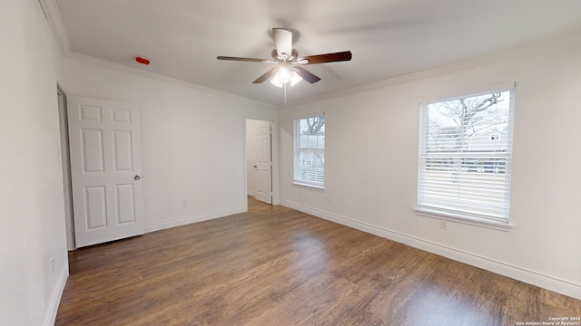 empty room featuring crown molding, ceiling fan, and dark hardwood / wood-style flooring